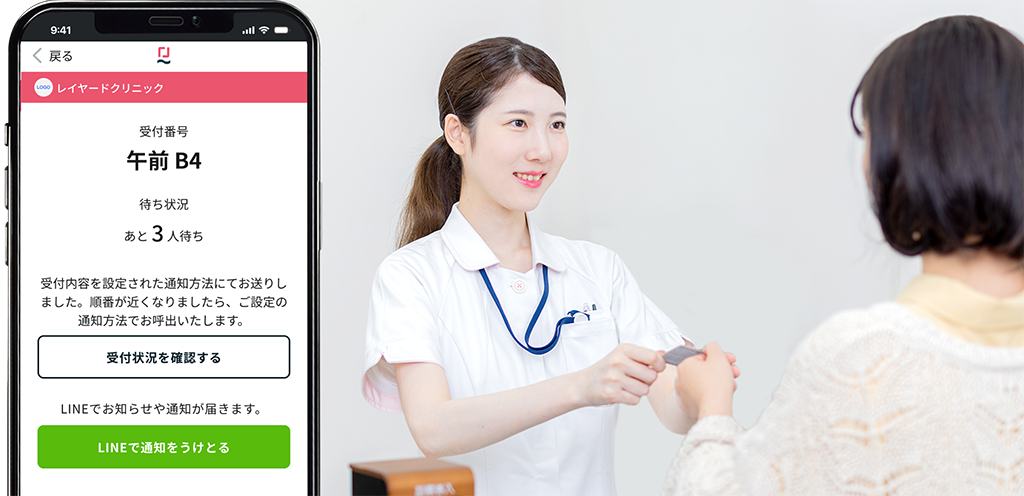 クリニックで受付スタッフが患者対応を行う様子（予約システムで直来患者にも対応）